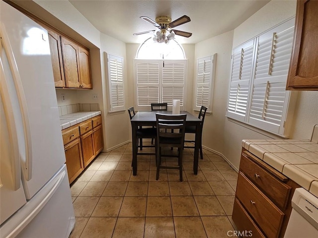 dining area featuring tile patterned floors and ceiling fan