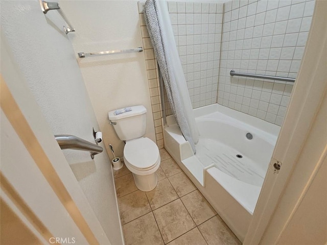 bathroom featuring tile patterned floors, toilet, and shower / bath combo with shower curtain