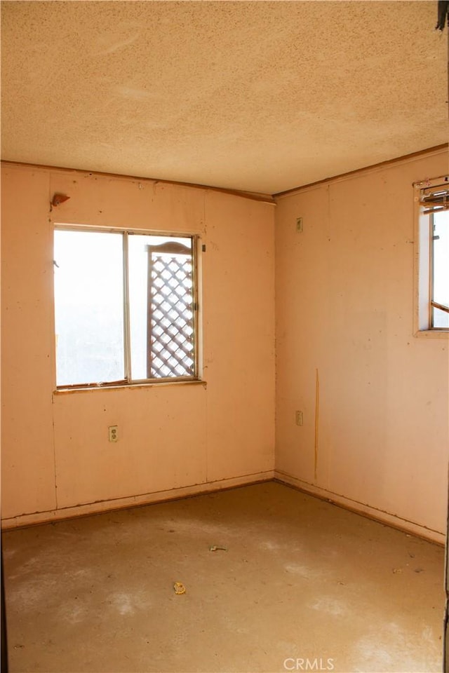 spare room featuring a textured ceiling