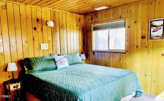 bedroom featuring wooden walls and wood ceiling