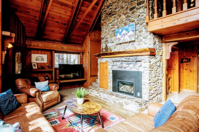 living room with beamed ceiling, a fireplace, wood ceiling, and wood walls