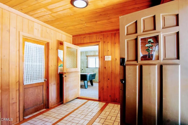 entrance foyer with wood walls and wooden ceiling