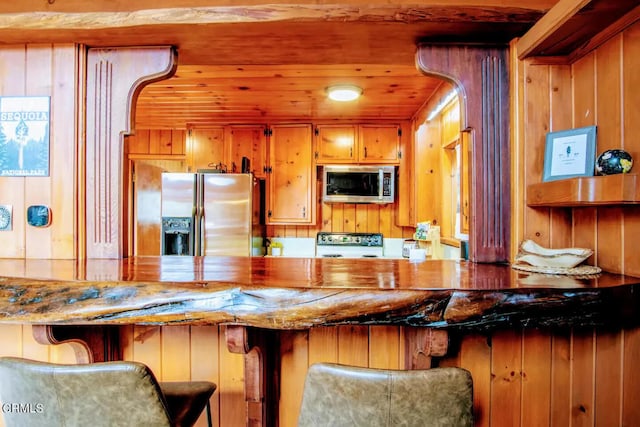 bar featuring appliances with stainless steel finishes