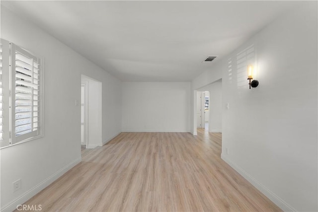 spare room featuring light wood-type flooring