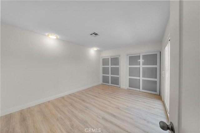 spare room with light hardwood / wood-style floors