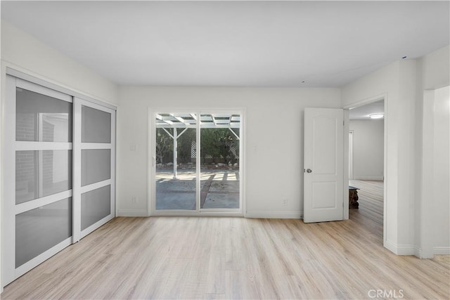 spare room featuring light wood-type flooring