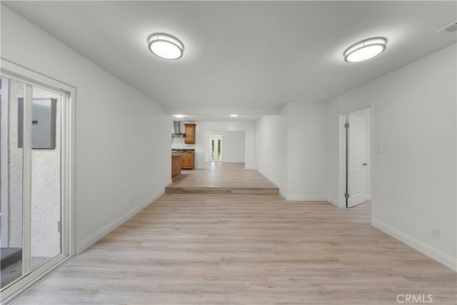 hallway with light hardwood / wood-style flooring