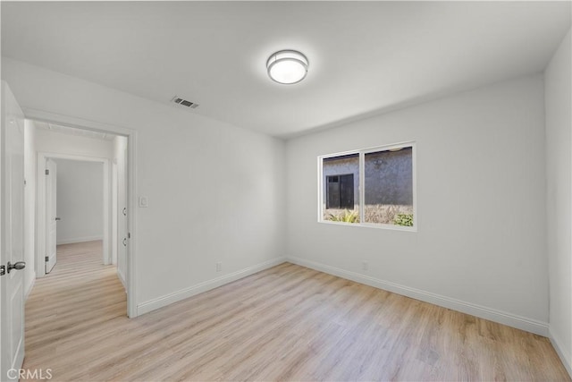 unfurnished room with light wood-type flooring