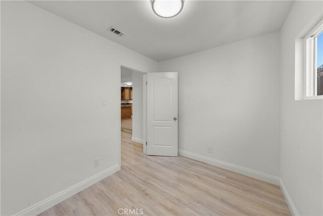 spare room with light hardwood / wood-style flooring