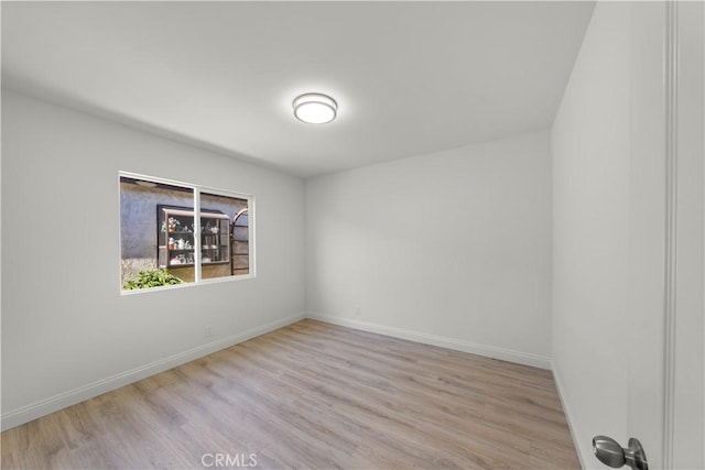 unfurnished room with light wood-type flooring