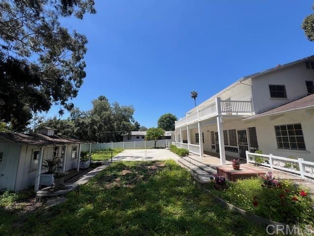 view of yard with a balcony and a patio area