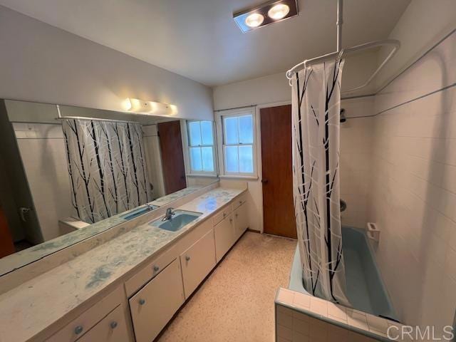 bathroom featuring vanity and shower / bath combo with shower curtain