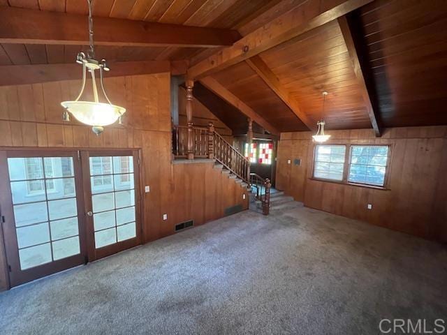 interior space with carpet floors, wooden walls, wooden ceiling, and lofted ceiling with beams