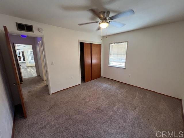 unfurnished bedroom featuring ceiling fan, carpet floors, and a closet