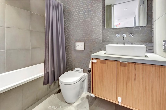 bathroom featuring tile patterned flooring, tasteful backsplash, toilet, vanity, and tile walls