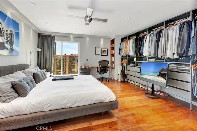 bedroom with ceiling fan and hardwood / wood-style flooring