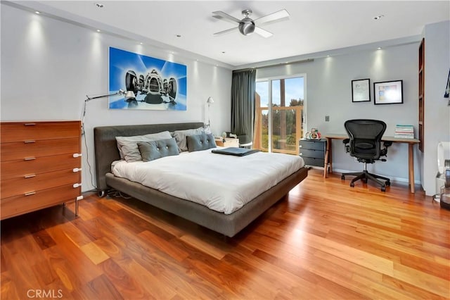 bedroom with wood finished floors, a ceiling fan, and access to outside