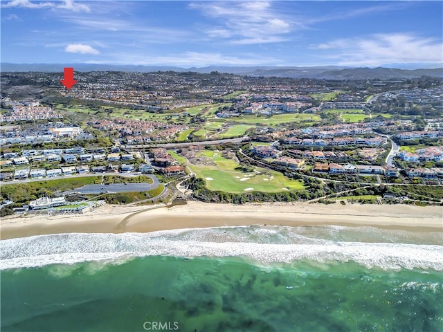 bird's eye view featuring a view of the beach and a water view