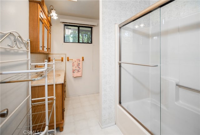 bathroom featuring vanity and enclosed tub / shower combo