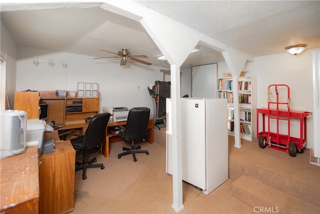 office area featuring light carpet, a textured ceiling, and ceiling fan