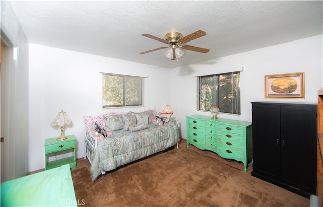 carpeted bedroom featuring a textured ceiling and ceiling fan