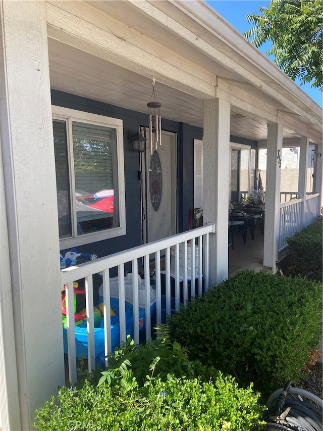 view of exterior entry featuring a porch