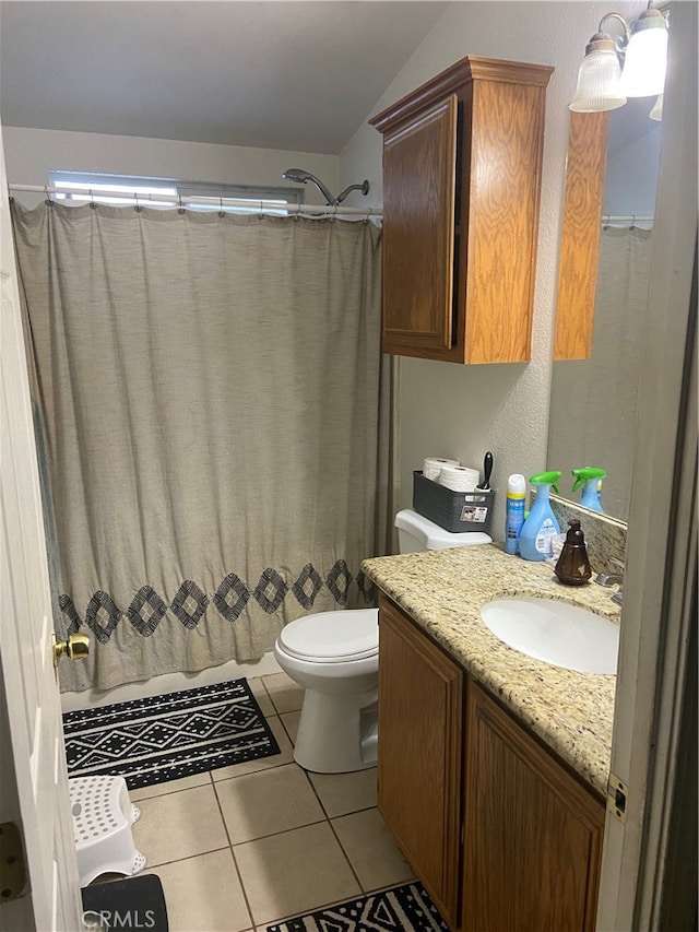 bathroom with tile floors, vanity, and toilet