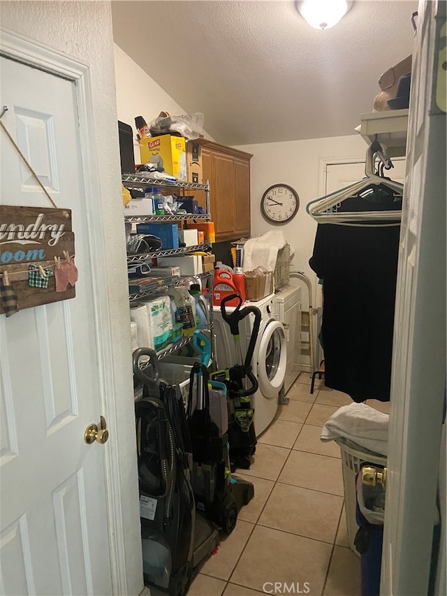 laundry area with cabinets, independent washer and dryer, and light tile flooring