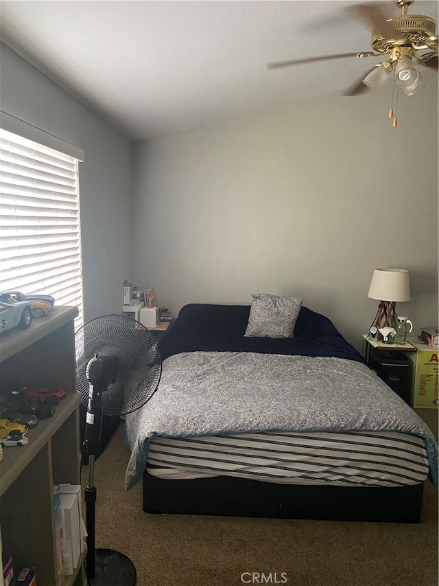 bedroom featuring ceiling fan and carpet