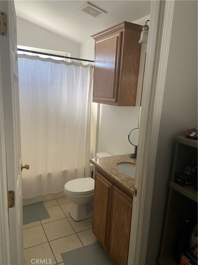 full bathroom with shower / tub combo, toilet, tile flooring, and vanity