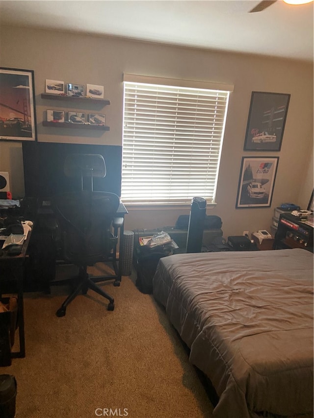 bedroom with ceiling fan and carpet floors