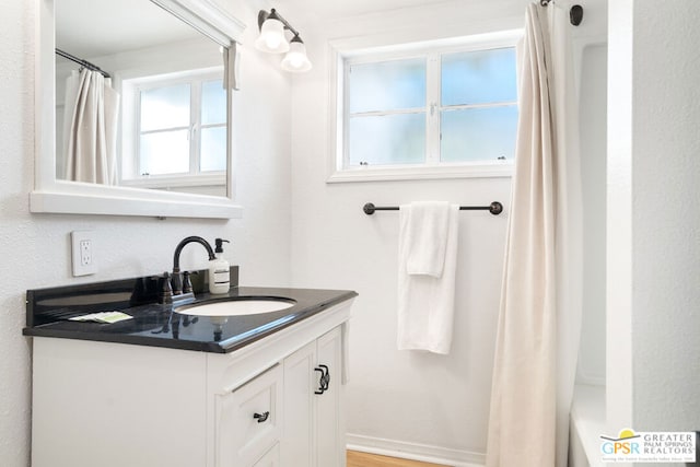 bathroom featuring vanity and shower / bath combo