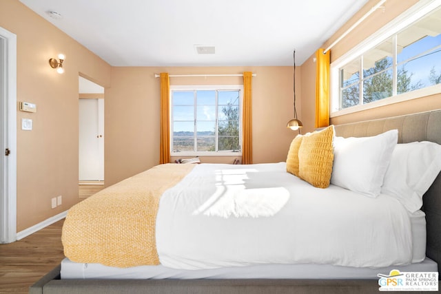 bedroom with hardwood / wood-style flooring