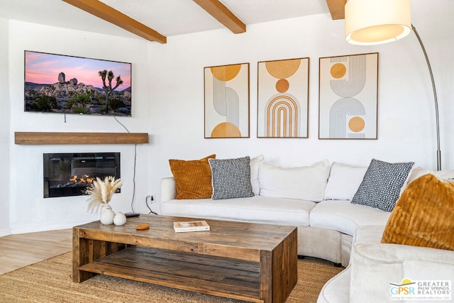 living room featuring light hardwood / wood-style flooring and beamed ceiling