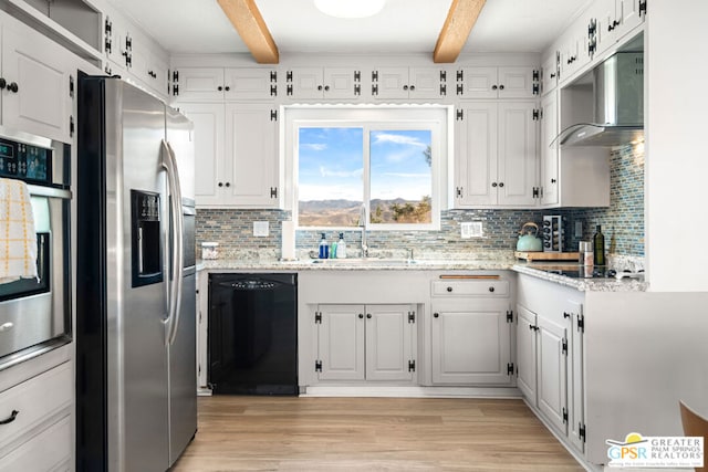 kitchen with white cabinets, light hardwood / wood-style floors, beam ceiling, and black appliances