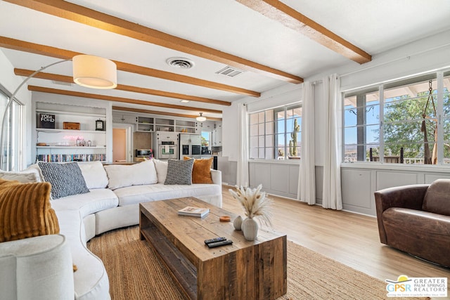 living room featuring light hardwood / wood-style flooring and beam ceiling