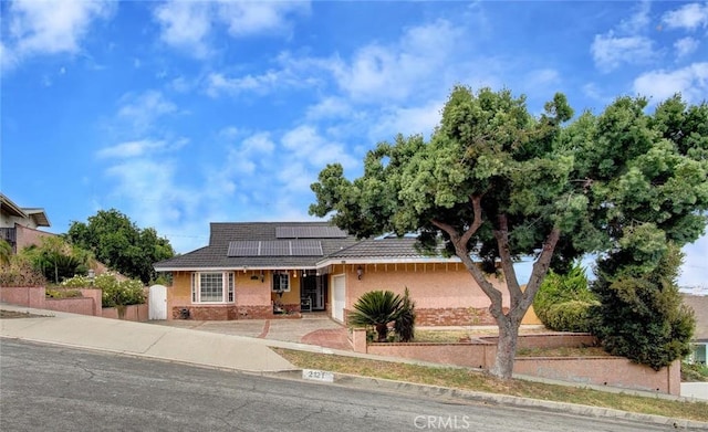 view of front of property with solar panels