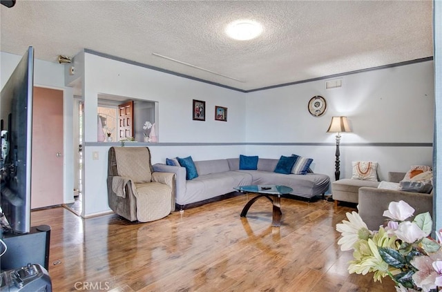 living room featuring hardwood / wood-style floors and a textured ceiling