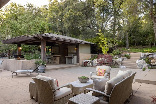 view of patio with an outdoor hangout area, a bar, and a grill