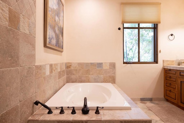 bathroom with tiled bath and vanity