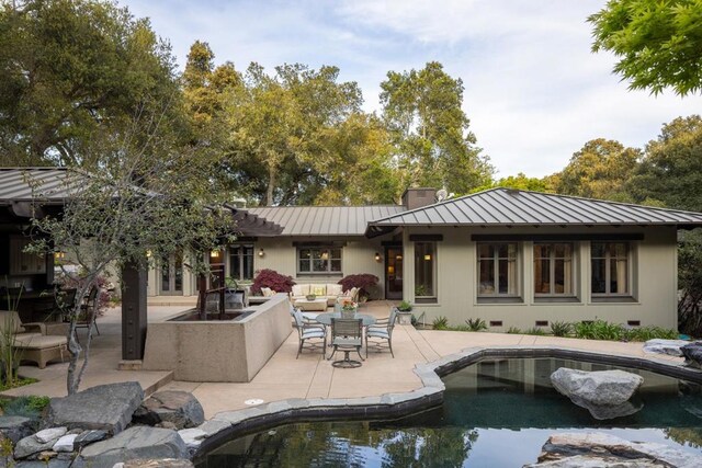 rear view of house with a patio