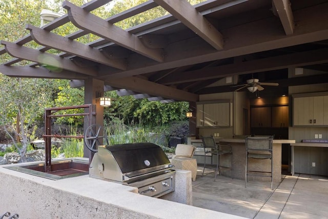 view of patio / terrace featuring a grill, an outdoor kitchen, an outdoor bar, ceiling fan, and a pergola