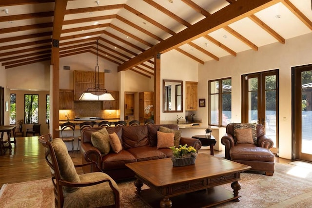 living room with high vaulted ceiling and beamed ceiling