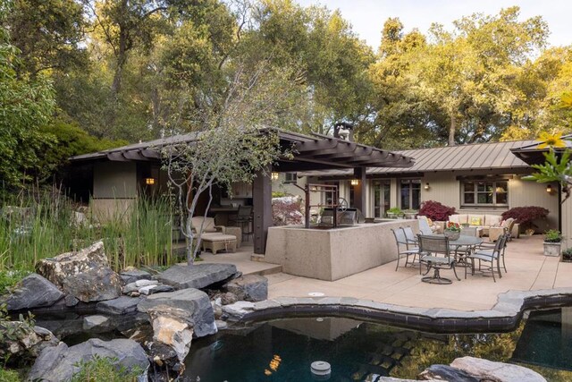 rear view of house with a pergola and a patio area