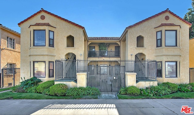 mediterranean / spanish-style house featuring a balcony