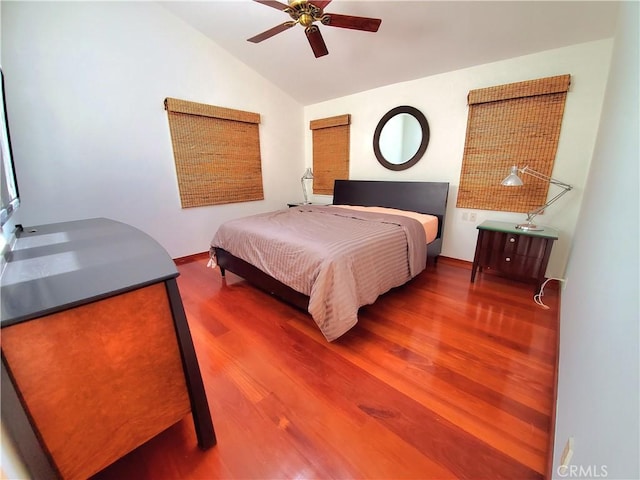 bedroom featuring hardwood / wood-style floors, ceiling fan, and lofted ceiling