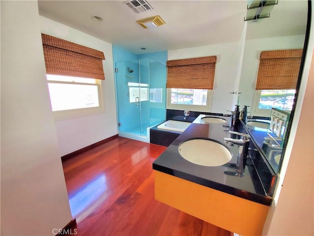 bathroom with sink, independent shower and bath, and hardwood / wood-style flooring