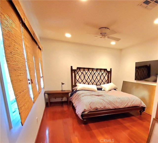 bedroom featuring ceiling fan, a closet, and hardwood / wood-style floors