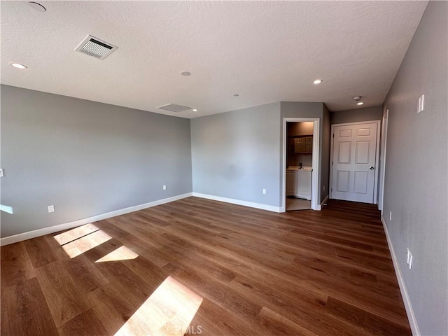 unfurnished room featuring a textured ceiling and dark wood-type flooring