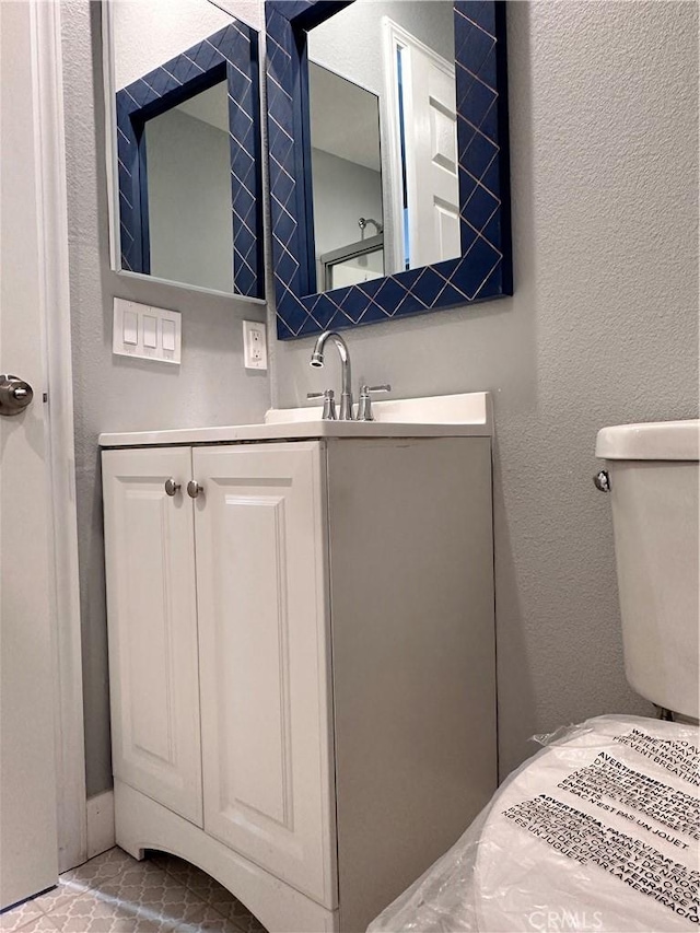 bathroom with vanity and toilet